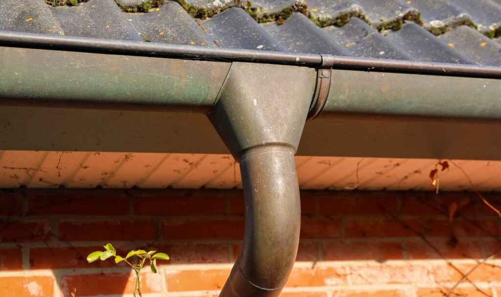 A dirty downspout before we cleaned it.