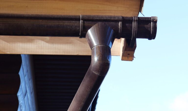 Downspout bend of a gutter just cleaned.